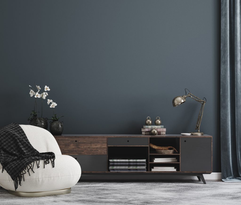 Modern minimalist living room with dark accent wall, boucle chair, and low-profile media console.
