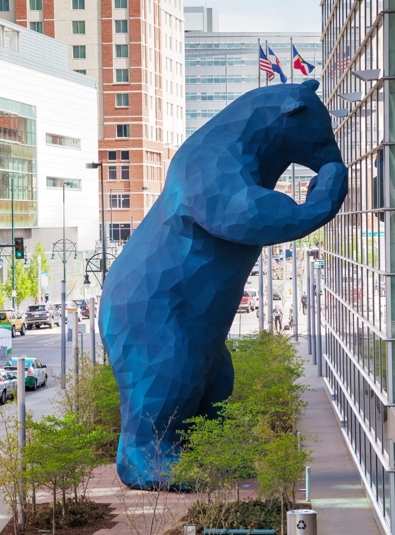 Blue Bear sculpture peering into the Colorado Convention Center in downtown Denver, symbolizing curiosity and discovery in the city’s vibrant core.