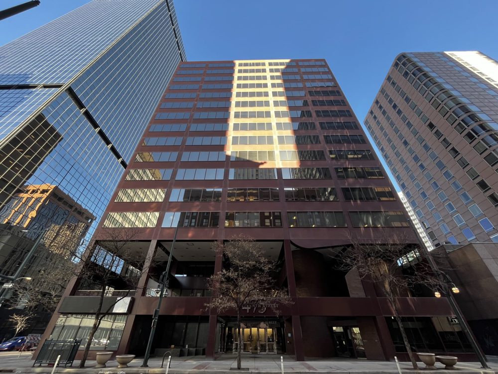 A street-level view of an older downtown Denver office tower at 475 17th Street, one of the buildings proposed for residential conversion.
